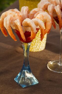Shrimp cocktail on martini glasses with cocktail shaker in the background