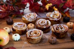 Baked Rose Apples made for a Thanksgiving holiday dessert surrounded by pumpkin chocolates