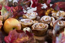 Baked Rose Apples made for a Thanksgiving holiday dessert surrounded by pumpkin chocolates