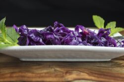 Purple Sauerkraut made with apples and vinegar, and plated with mint leaves for a gourmet meal
