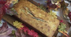 Thanksgiving banana bread plated on a wood tray surrounded by autumn leaves and a turkey decoration Banana Bread Home Style