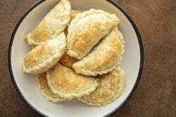 Golden baked Argentinian meat Empanadas just made and placed in a bowl
