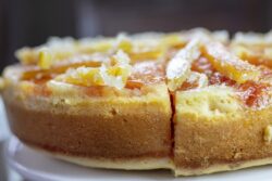Candied Orange Upside down cake made with orange and lemon rinds on a white creamic plate