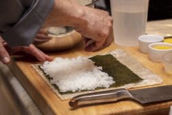 Chef preparing ingredients and teaching how to make Sushi