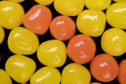 Yellow and Orange Candy Sour Balls creating a design background