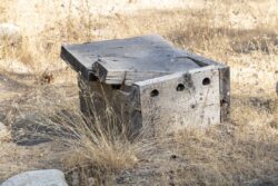 Old wooden abandoned box on dirt road