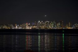 View of metro San Diego from Shelter Island at night with reflection of lights in the water