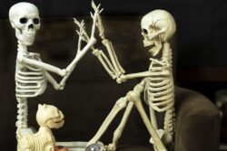 Two Halloween Skeletons getting ready for the holiday