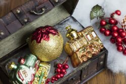 Christmas decorations set in a vintage jewelry box on a wood table