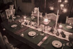 Skeleton family gathered for a Halloween dinner celebrating the holiday at a formal dining table