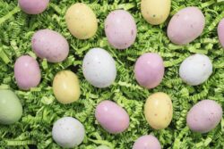 Malted Candy Easter Eggs laid on a bed of green crepe paper