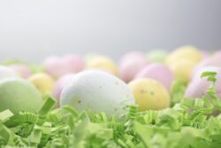 Malted Candy Easter Eggs laid on a bed of green crepe paper