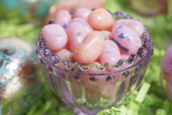 Easter Eggs and Jelly Beans in a glass container and on green crepe paper